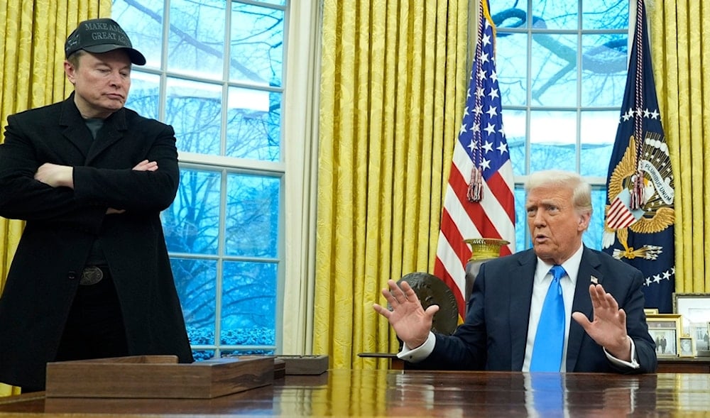 President Donald Trump speaks with reporters as Elon Musk listens in the Oval Office at the White House, Tuesday, Feb. 11, 2025, in Washington. (AP)