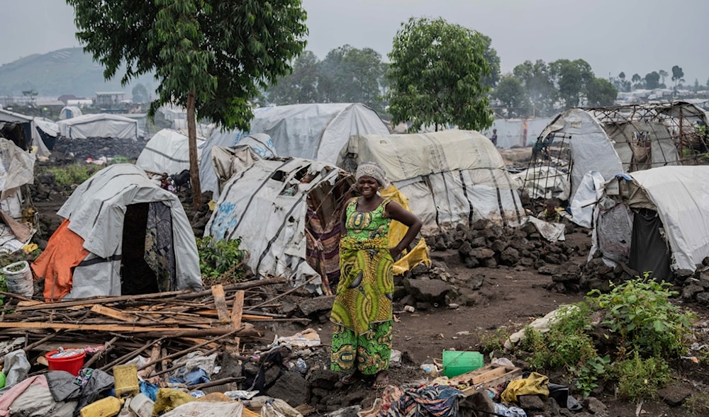 A displaced woman prepares to leave the camp following orders by M23 rebels in Goma, Democratic Republic of the Congo, Tuesday, Feb. 11, 2025. (AP)