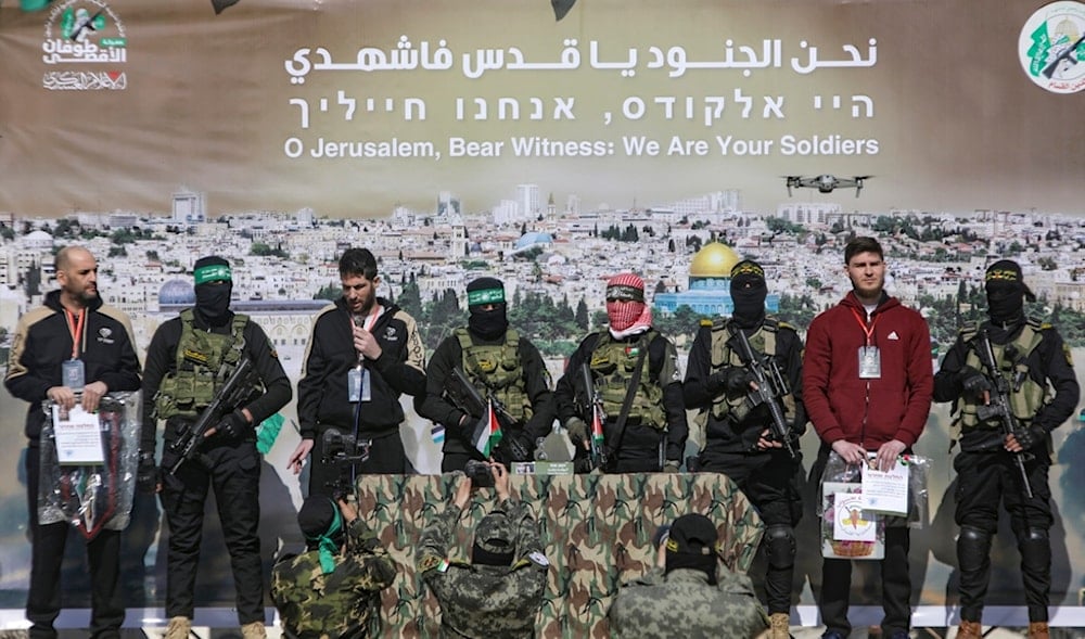 Israeli captives are escorted by Hamas and Islamic Jihad fighters on a stage before being handed over to the Red Cross in Khan Younis, southern Gaza Strip, Saturday Feb. 15, 2025. (AP)