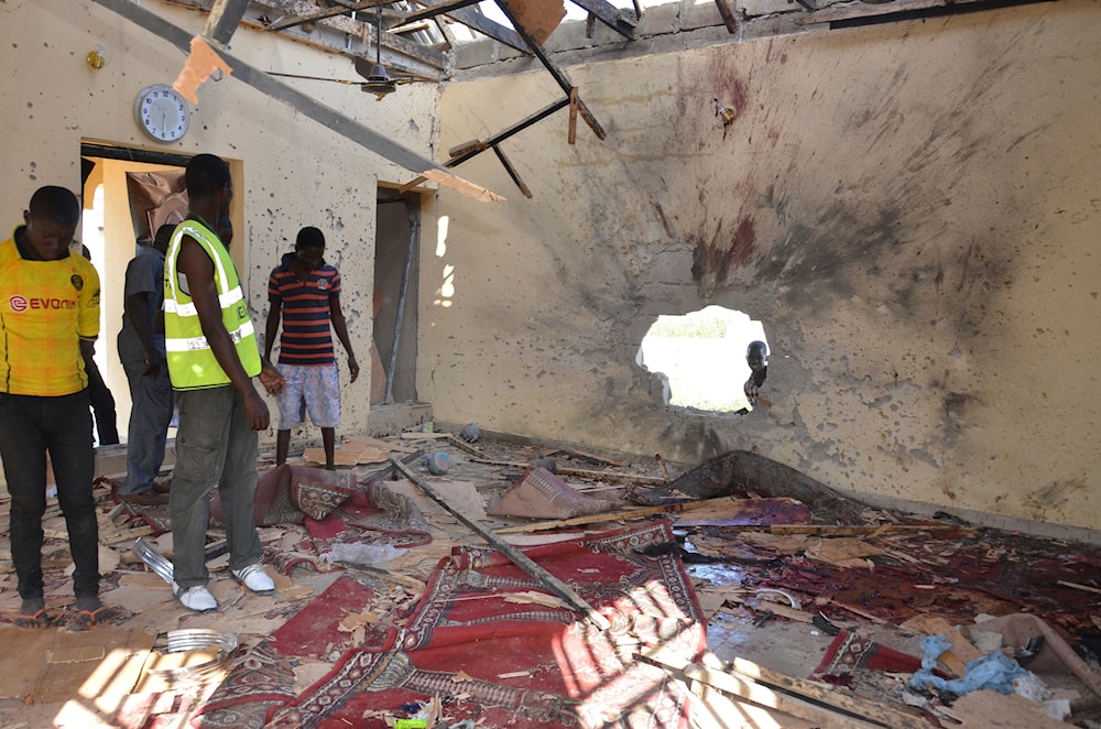 In this Friday, Oct. 23, 2015 file photo, people inspect a damaged mosque following a Boko Haram attack in Maiduguri, Nigeria. (AP)