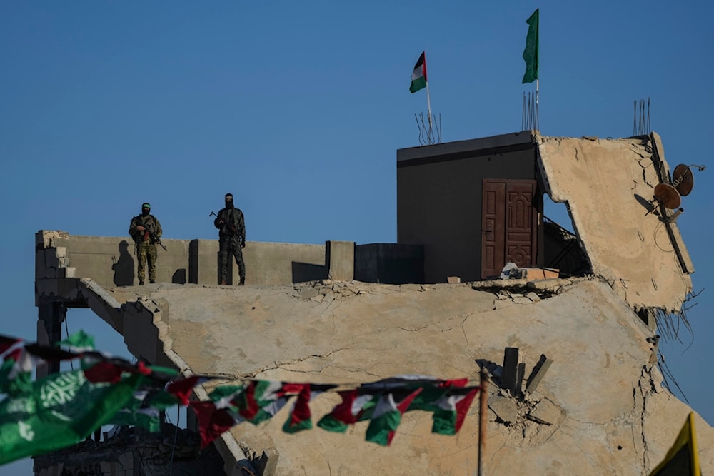 Hamas fighters take up a position ahead of a hostages' release in Khan Younis, Gaza Strip, Saturday, Feb. 15, 2025. (AP Photo/Abdel Kareem Hana)