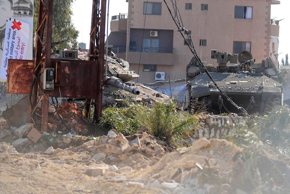 Israeli tanks sitting in Mays al-Jabal village are seen from the window of an UN peacekeeper armoured vehicle, southern Lebanon, Monday, Jan. 27, 2025 (AP)