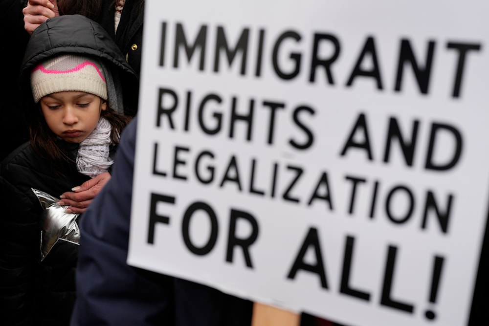 Nadia Ramirez, 7, stands with her mom during the Stop The Attacks on Immigrants protest in Chicago, Saturday, Feb. 8, 2025. (AP )