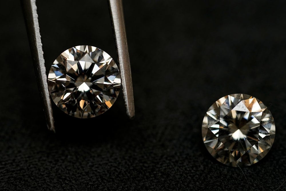 A lab grown diamond, left, and a natural diamond are displayed at Bario Neal, a jewelry store, in Philadelphia, Wednesday, Feb. 7, 2024 (AP)