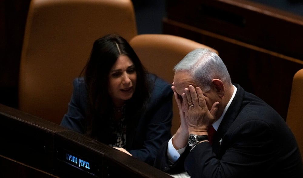 Israeli Prime Minister Benjamin Netanyahu confers with Minister of Transport and Road Safety Miri Regev as lawmakers convene in the Knesset, Feb. 20, 2023. (AP)