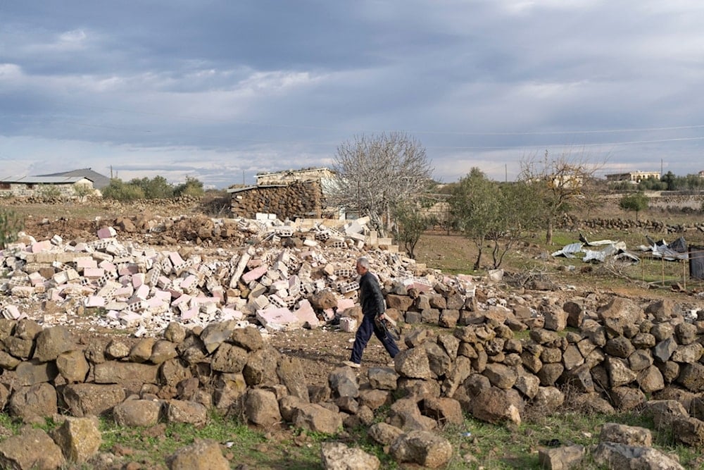 A man walks past a home that was demolished by the Israeli military, in the village of Rafid, on the outskirts of Quneitra, Syria, Sunday, Jan. 5, 2025 (AP)