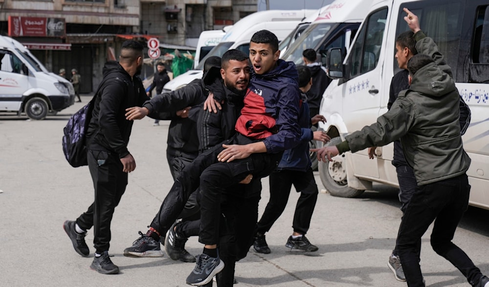 People carry an injured Palestinian during confrontations with Israeli occupation forces in the West Bank city of Nablus, Sunday, Feb. 16, 2025. (AP)