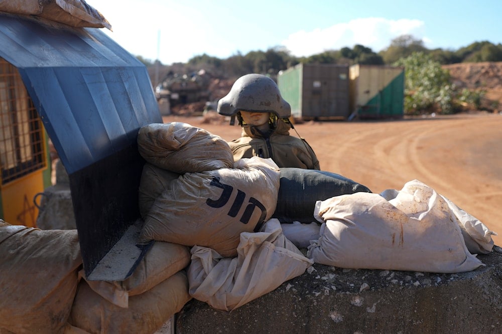 A mannequin wearing a helmet stands at the entrance of a military near the occupied Palestinian border with Lebanon, Thursday, Dec. 5, 2024. (AP)