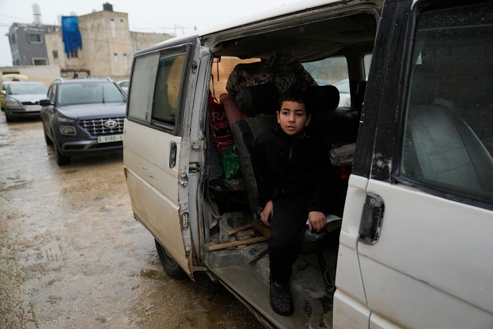 Palestinians who fled the Israeli military operation in the Nur Shams refugee camp arrive at a temporary shelter for displaced people in the West Bank town of Anabta, near Tulkarem, Monday, Feb. 10, 2025 (AP)