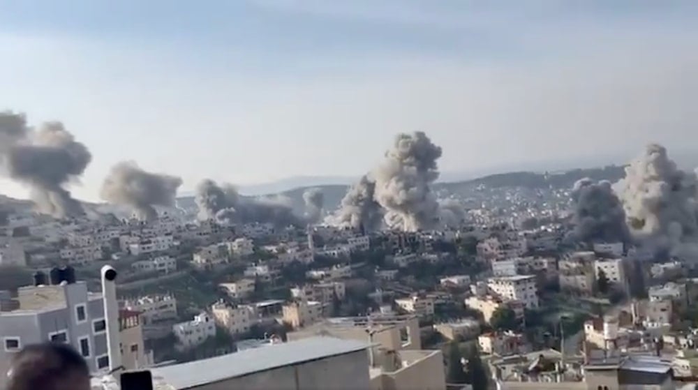 Screengrab of footage circulating on social media showing buildings being simultaneously demolished in Jenin, occupied West Bank. (@MariamBarghouti)