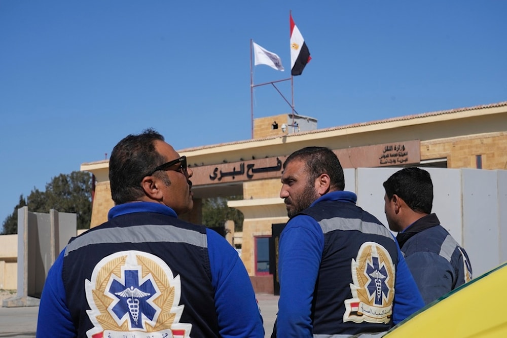 Ambulance workers wait for patients and injured Palestinians from Gaza cross through the Rafah border crossing, Egypt, Saturday, Feb. 1, 2025 (AP)