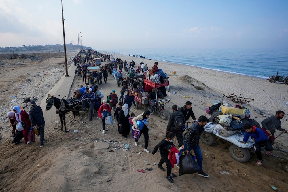 Displaced Palestinians walk on a road in central Gaza to return to their homes in the northern Gaza Strip, Friday, Jan. 31, 2025. (AP Photo/Abdel Kareem Hana)
