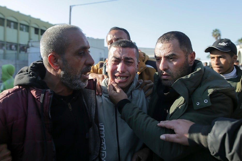 A freed Palestinian prisoner, center, reacts as he arrives in the Gaza Strip after being released from an Israeli prison following a ceasefire agreement between Hamas and Israel in Khan Younis, Feb. 1, 2025 (AP)