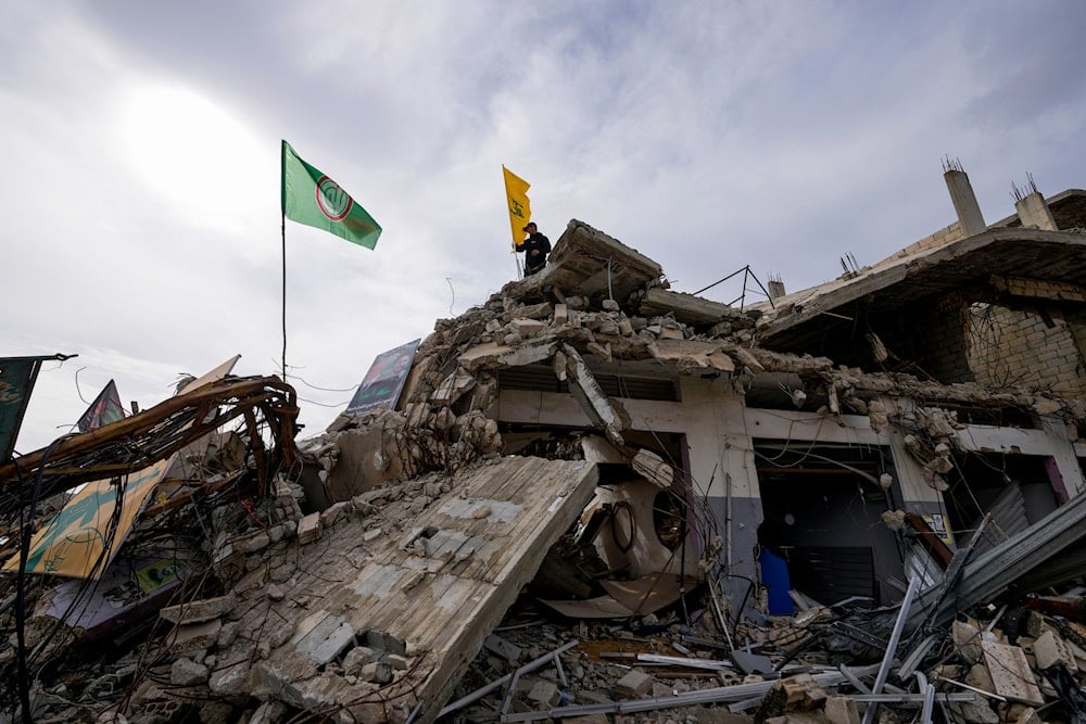 A Lebanese man checks the destruction in his village caused by the Israeli air and ground offensive, in the town of Kfar Kila, southern Lebanon, Wednesday, Feb. 19, 2025. (AP Photo/Hassan Ammar)