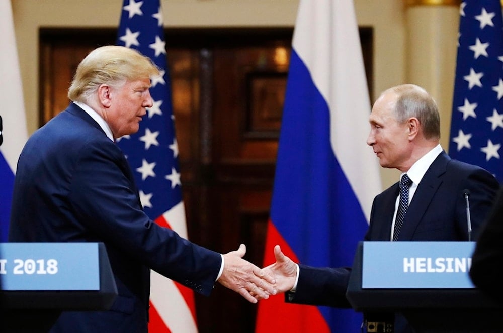 In this file photo taken on Monday, July 16, 2018, US President Donald Trump shakes hand with Russian President Vladimir Putin at the end of the press conference after their meeting at the Presidential Palace in Helsinki, Finland (AP)