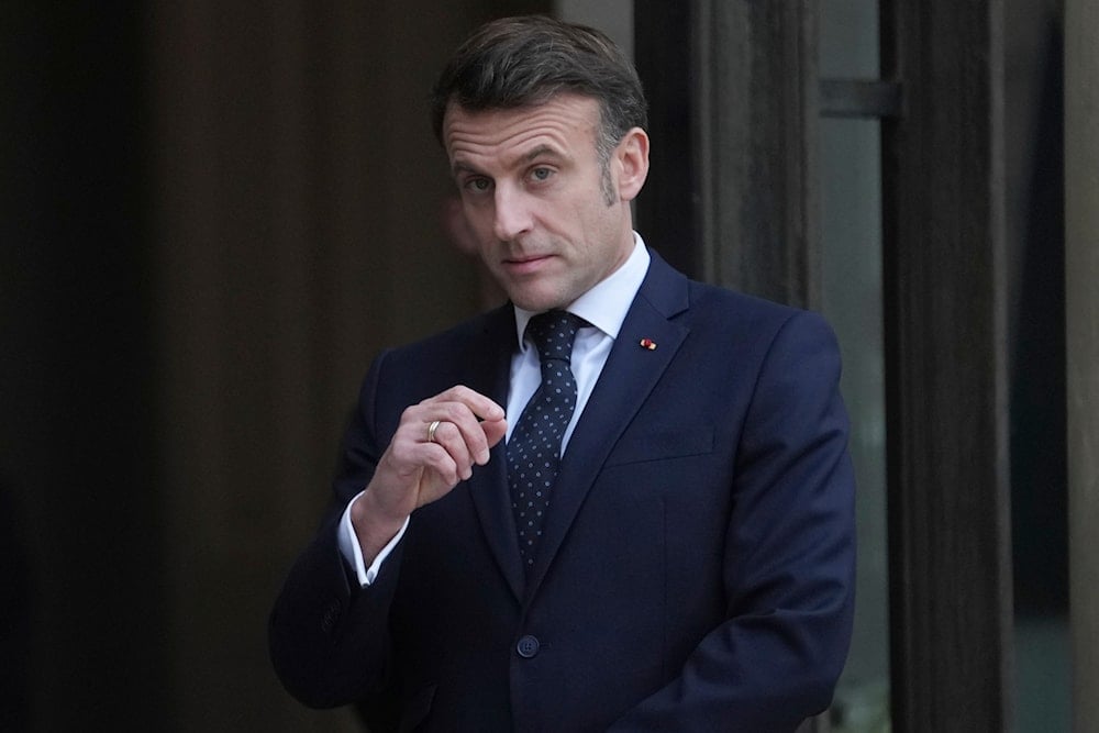 France's President Emmanuel Macron waits for Romania's Interim President Ilie Boloja, before a meeting on European security, Wednesday, Feb. 19, 2025, at the Elysee Palace in Paris. (AP Photo/Thibault Camus)