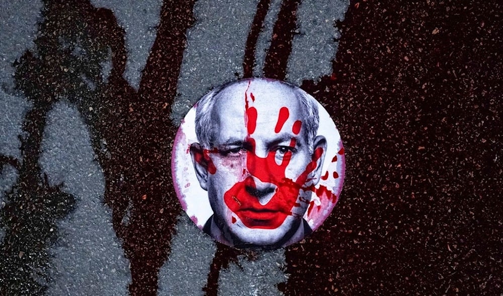 Relatives and supporters of Israeli captives stuck a sticker with the face of Israeli Prime Minister Benjamin Netanyahu on a road in which they poured red liquid, symbolizing blood, Feb. 17, 2025. (AP)