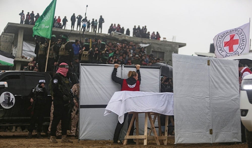 Hamas fighters hand over a coffin containing one of four bodies to the Red Cross in Khan Younis, southern Gaza Strip, Thursday, Feb. 20, 2025. (AP)