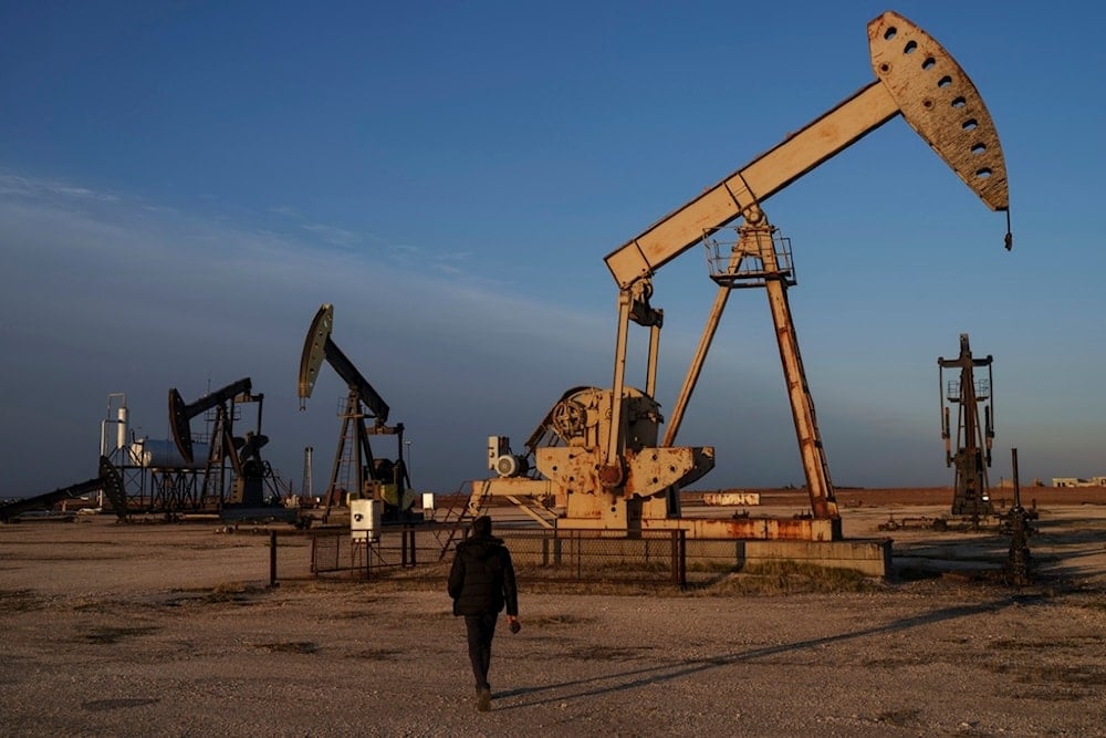 A worker walks past idle pumpjacks at an oil field on the outskirts of the northeastern Syrian city of Qamishli, Monday, Feb. 3, 2025.(AP Photo/Bernat Armangue)