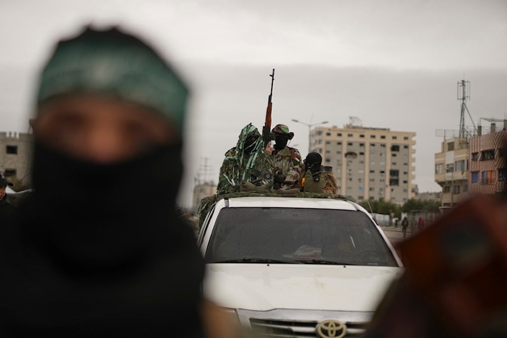 Hamas fighters take position ahead of the planned release of Israeli hostages set to be handed over to the Red Cross in Nuseirat, Gaza Strip, Saturday, Feb. 22, 2025. (AP Photo/Abdel Kareem Hana)