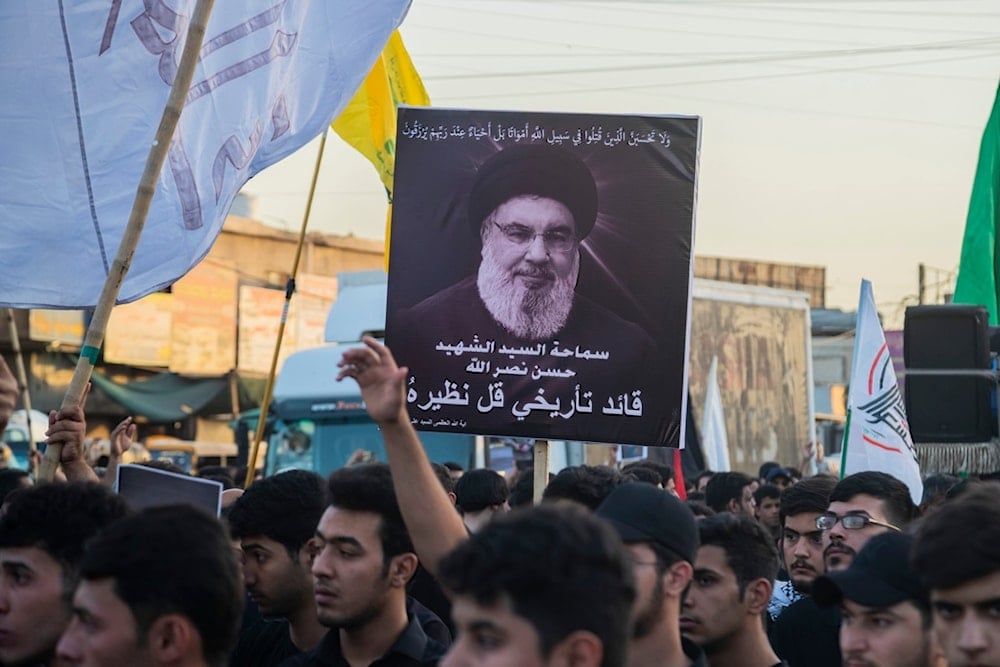 Iraqis hold pictures of Lebanon's Hezbollah leader Sayyed Hassan Nasrallah during a symbolic funeral in Sadr City, Baghdad, Iraq, Sunday, Sept. 29, 2024. (AP)