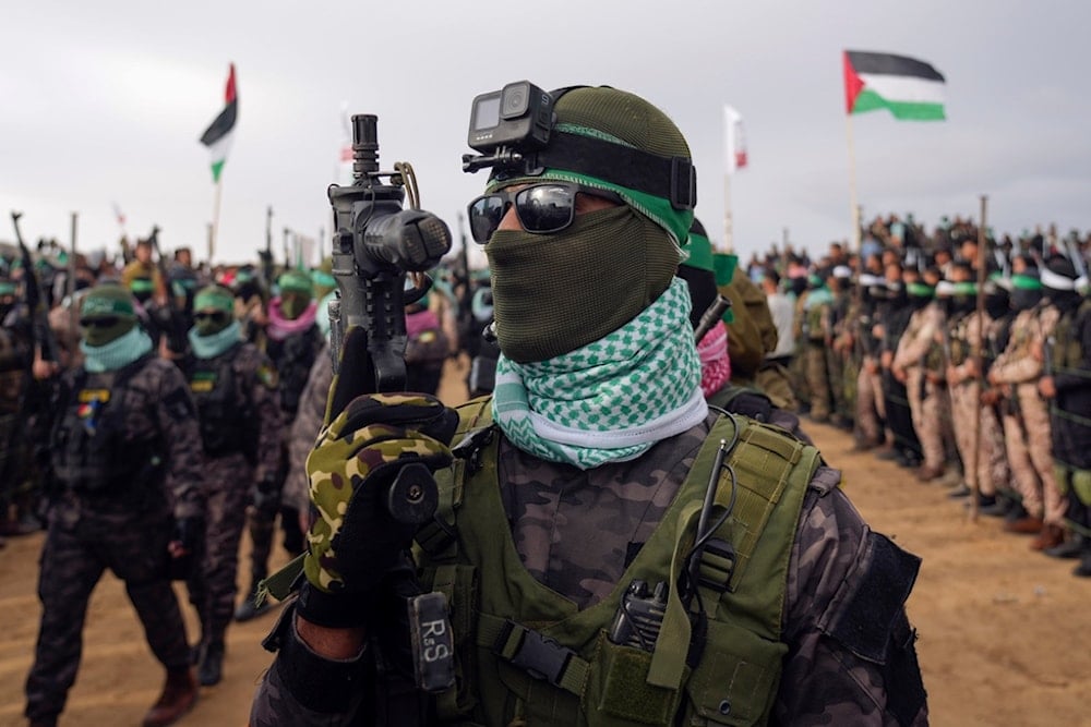 Hamas fighters take up a position ahead of handing over four bodies to the Red Cross in Khan Younis, southern Gaza Strip, Thursday, Feb. 20, 2025 (AP)