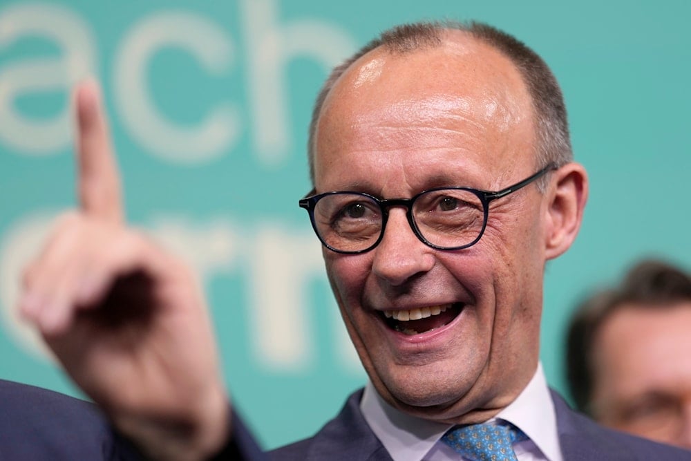 Friedrich Merz, the candidate of the mainstream conservative Christian Democratic Union party, reacts to the speech of Markus Soeder, leader of CSU and Minister-President of Bavaria, at the party headquarters in Berlin, Germany, Sunday, Feb. 23, 2025 (AP)