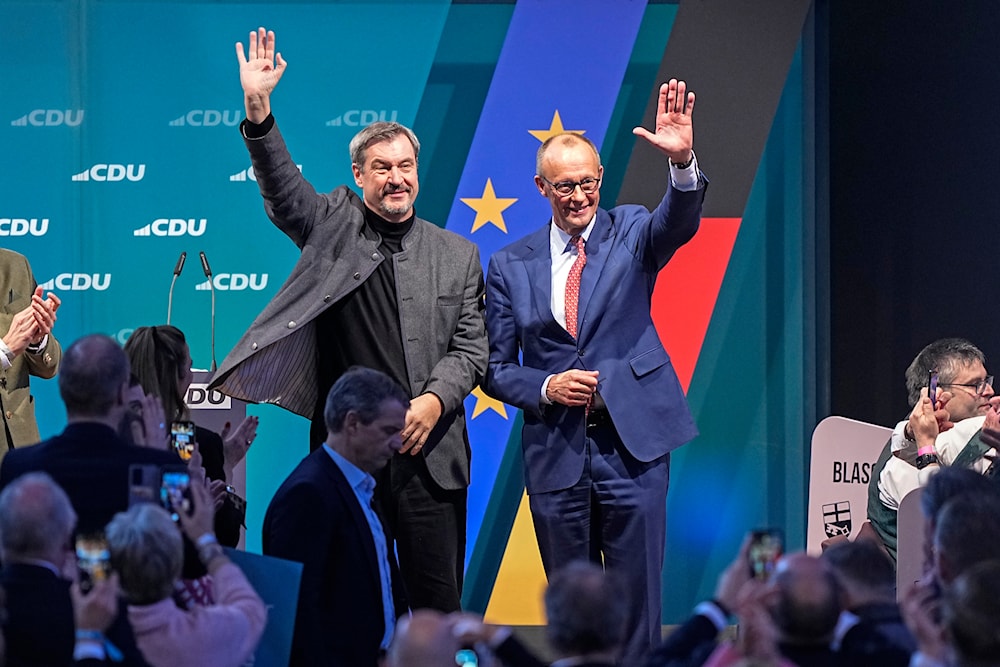 The top candidate for Chancellor, Friedrich Merz of the Christian Democratic Union (CDU), right, and Bavaria Governor Markus Soeder wave to supporters at a party event in Brilon, Germany, Jan. 19, 2025. (AP)