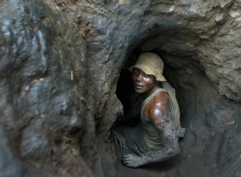 A man enters one of the tunnels dug with shovels in the Shinkolobwe Cobalt mine, in South Eastern, Democratic Republic of Congo, April 10, 2004 (AP)