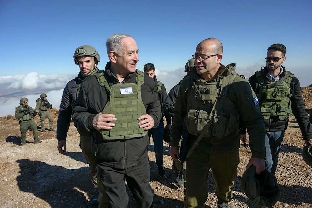 Israel's Prime Minister Benjamin Netanyahu, left, visits Israeli occupation forces in a buffer zone inside Syria, Tuesday, Dec. 17, 2024. (Israel Government Press Office via AP)