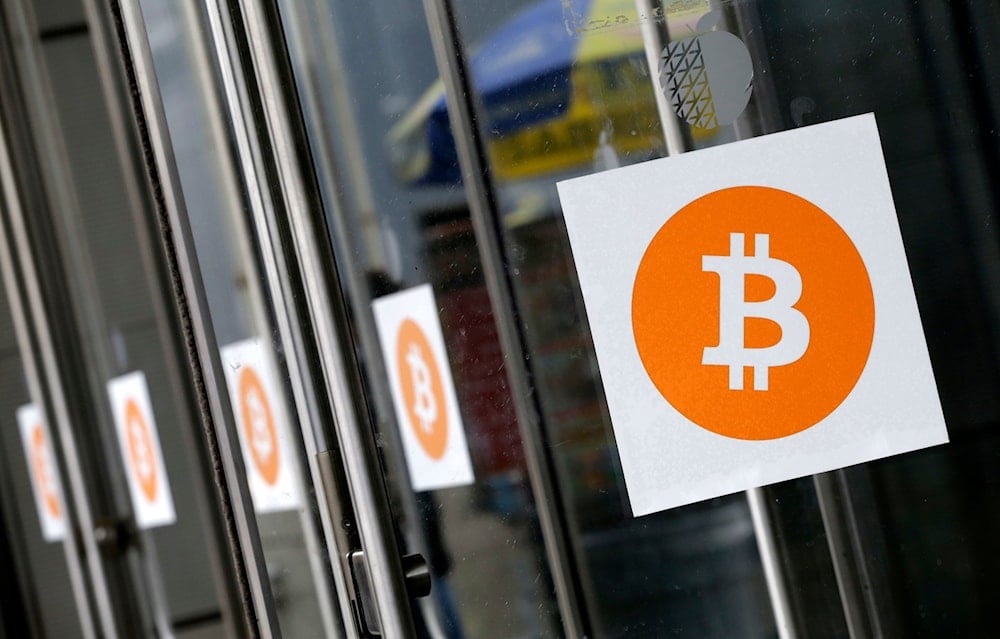 Bitcoin logos are displayed at the Inside Bitcoins conference and trade show on April 7, 2014, in New York (AP)