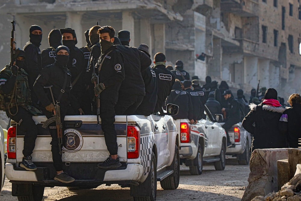 Syrian security forces leave the area after an operation in Tadamon, a suburb of Damascus, Syria, Monday, Feb. 17, 2025 (AP)