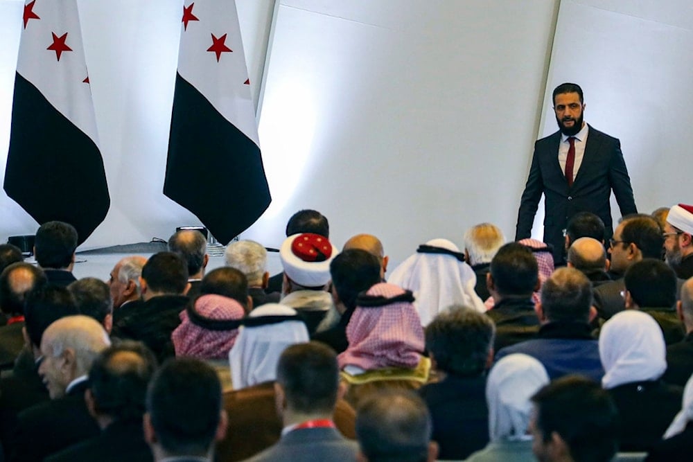 Syria's interim president Ahmad al-Sharaa, right, leaves the podium after speaking during Syria's national dialogue conference at the People’s Palace in Damascus, Syria, Tuesday Feb. 25, 2025 (AP)