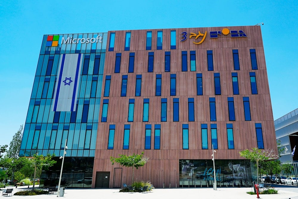 An Israeli flag is draped over the Microsoft offices in a building in Bir al Saba'a, Occupied Palestine, on Thursday, May 30, 2024 (AP)