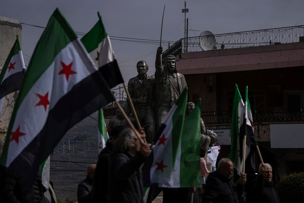 People participate in a rally in the town of Majdal Shams, close to the Syrian border, demanding the Israeli occupation return the occupied Golan Heights to Syria, Friday Feb. 14, 2025 (AP)