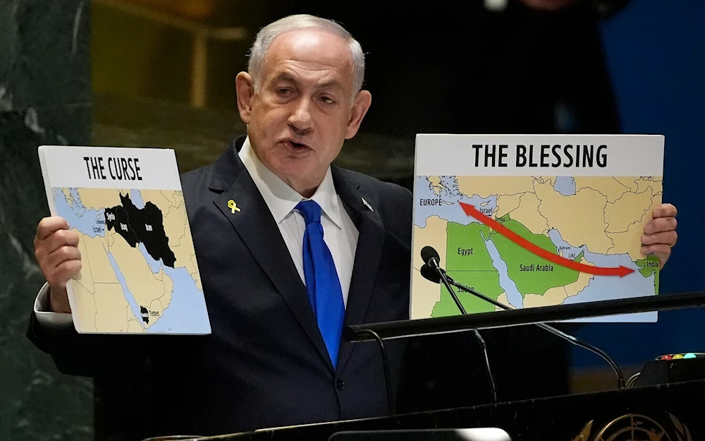 Israeli Prime Minister Benjamin Netanyahu hold signs as he addresses the 79th session of the UN General Assembly, September 27, 2024 (AP)