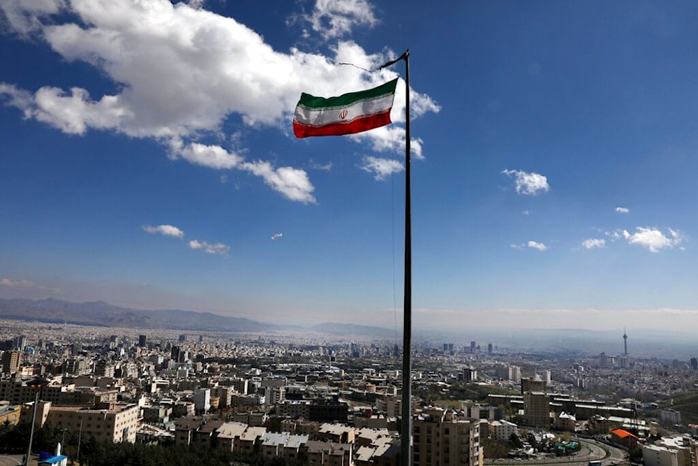 Iran's national flag waves in northern Tehran, Iran, Tuesday, March 31, 2020. (AP)