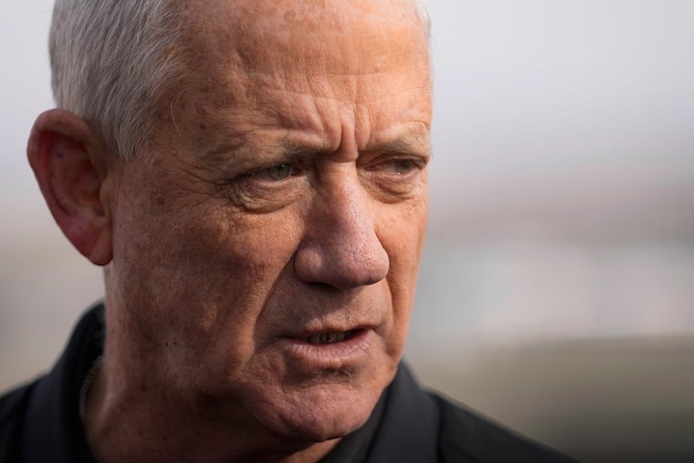 Israeli politician Benny Gantz speaks with the media on a viewpoint near the so-called Alpha Line that separates the Israeli-occupied Golan Heights from Syria, Sunday, Dec. 8, 2024 (AP)