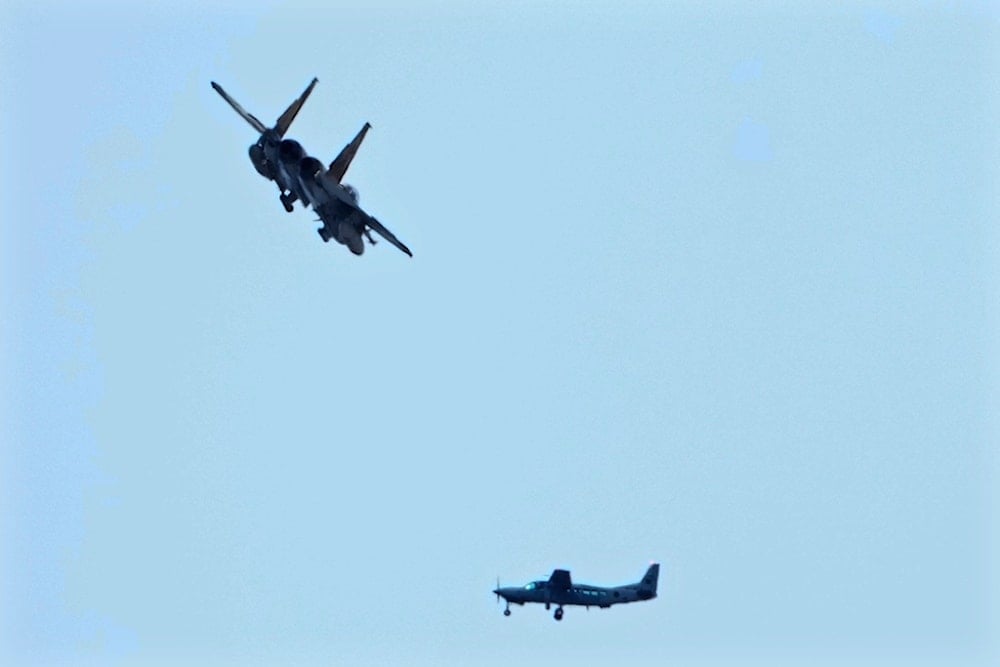 An Israeli fighter jet flies over a Lebanese airforce Cessna plane during the funeral ceremony of Hezbollah leaders Sayyed Hassan Nasrallah and Sayyed Hashem Safieddine in the Sports City Stadium in Beirut, Lebanon, Sunday, Feb. 23, 2025 (AP)