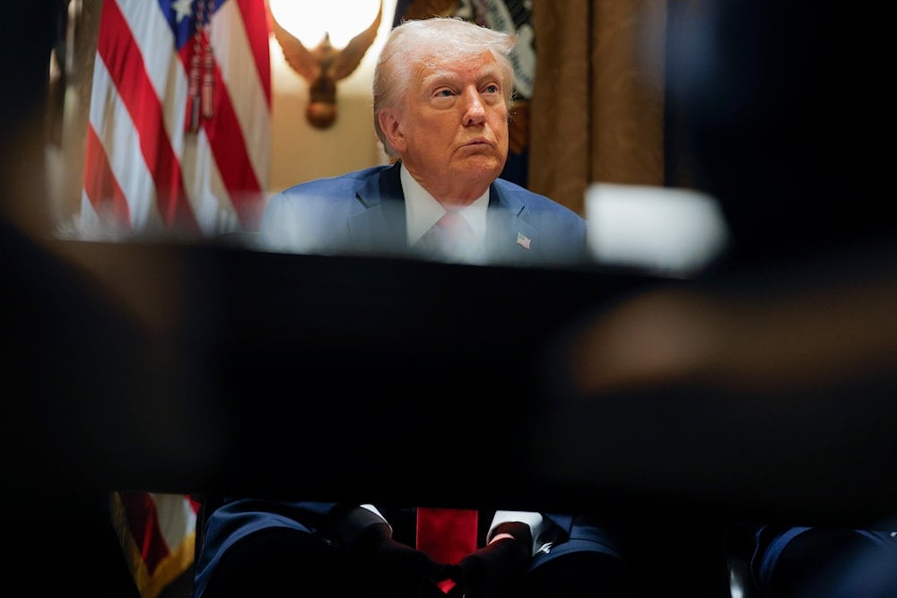 President Donald Trump listens during a Cabinet meeting at the White House in Washington, Tuesday, Feb. 26, 2025. (Pool via AP)