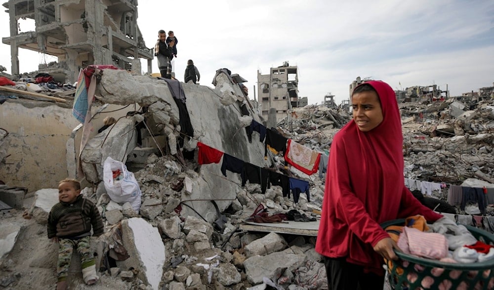 Members of the Nijim family hang laundry on the ruins of their house in Jabalia, Gaza Strip, on Tuesday, Feb. 18, 2025. (AP)