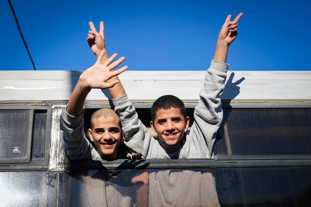 Freed Palestinian teenagers wave as they are greeted upon their arrival after being released from an Israeli prison, Khan Younis, Gaza Strip, Thursday, Feb. 27, 2025 (AP Photo/Abdel Kareem Hana)