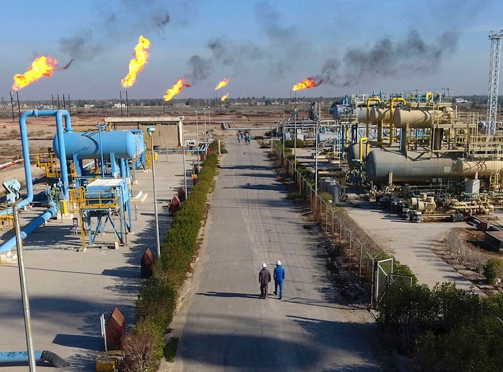 Laborers walk down a path in the Nihran Bin Omar field north of Basra, Iraq, 340 miles (550 kilometers) southeast of Baghdad, on Thursday, Jan. 12, 2017. (AP)