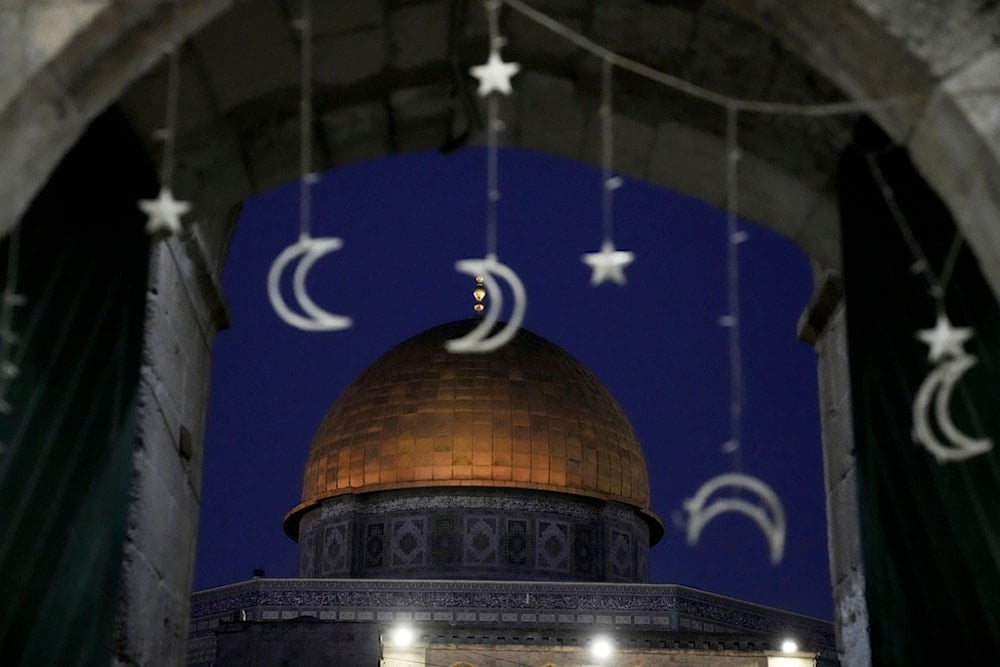 Holiday lights decorate a doorway near the Dome of the Rock Mosque in the Al-Aqsa Mosque compound ahead of the start of the Islamic holy month of Ramadan, in occupied al-Quds, occupied Palestine, Friday, Feb. 28, 2025 (AP)