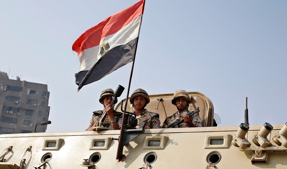 Egyptian Army soldiers stand guard outside the Rabaah al-Adawiya mosque, in the center of the largest protest camp of supporters of ousted President Mohammed Morsi, Cairo, Egypt, Aug. 16, 2013. (AP)