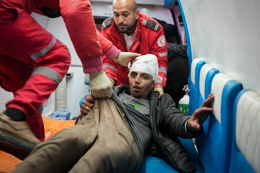 A wounded youth is brought to al-Aqsa Martyrs Hospital after Israeli army airstrikes targeted the Nuseirat and Maghazi camps in Deir al-Balah, central Gaza Strip, on Thursday, January 2, 2025 (AP)