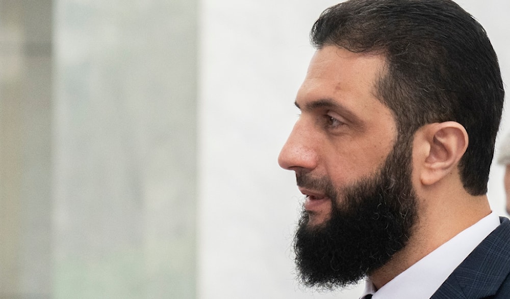 Syria's de facto leader Ahmad al-Sharaa walks in the presidential palace ahead of his meeting with Walid Ellafi, Libyan minister of state for communication and political affairs, in Damascus, Dec. 28, 2024. (AP)