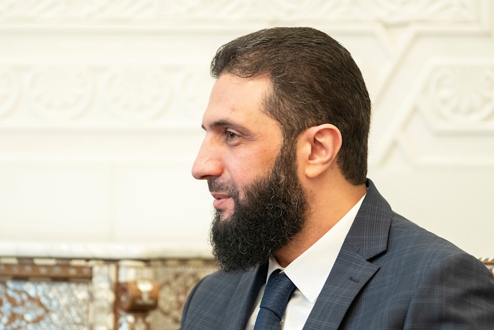 Syria's de facto leader Ahmad al-Sharaa, formerly known as Abu Mohammed al-Golani, meets with Walid Ellafi, Libyan minister of state for communication and political affairs, in the presidential palace in Damascus, Saturday, Dec. 28, 2024. (AP)