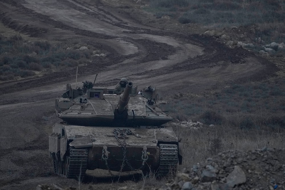 An Israeli soldier stands on a tank near the Golan Heights-Syria line. Dec. 21, 2024 (AP)