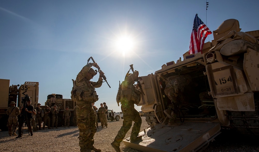 Crewmen enter Bradley fighting vehicles at a US military base at an undisclosed location in Northeastern Syria, on Nov. 11, 2019. (AP)